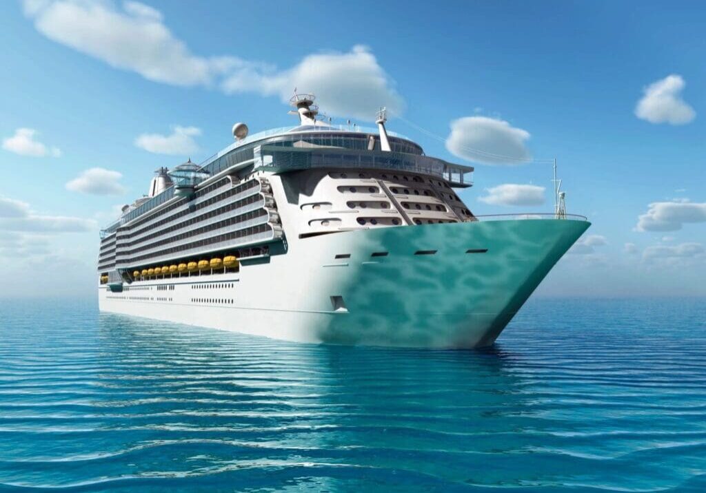 A large cruise ship in the ocean with blue skies above.